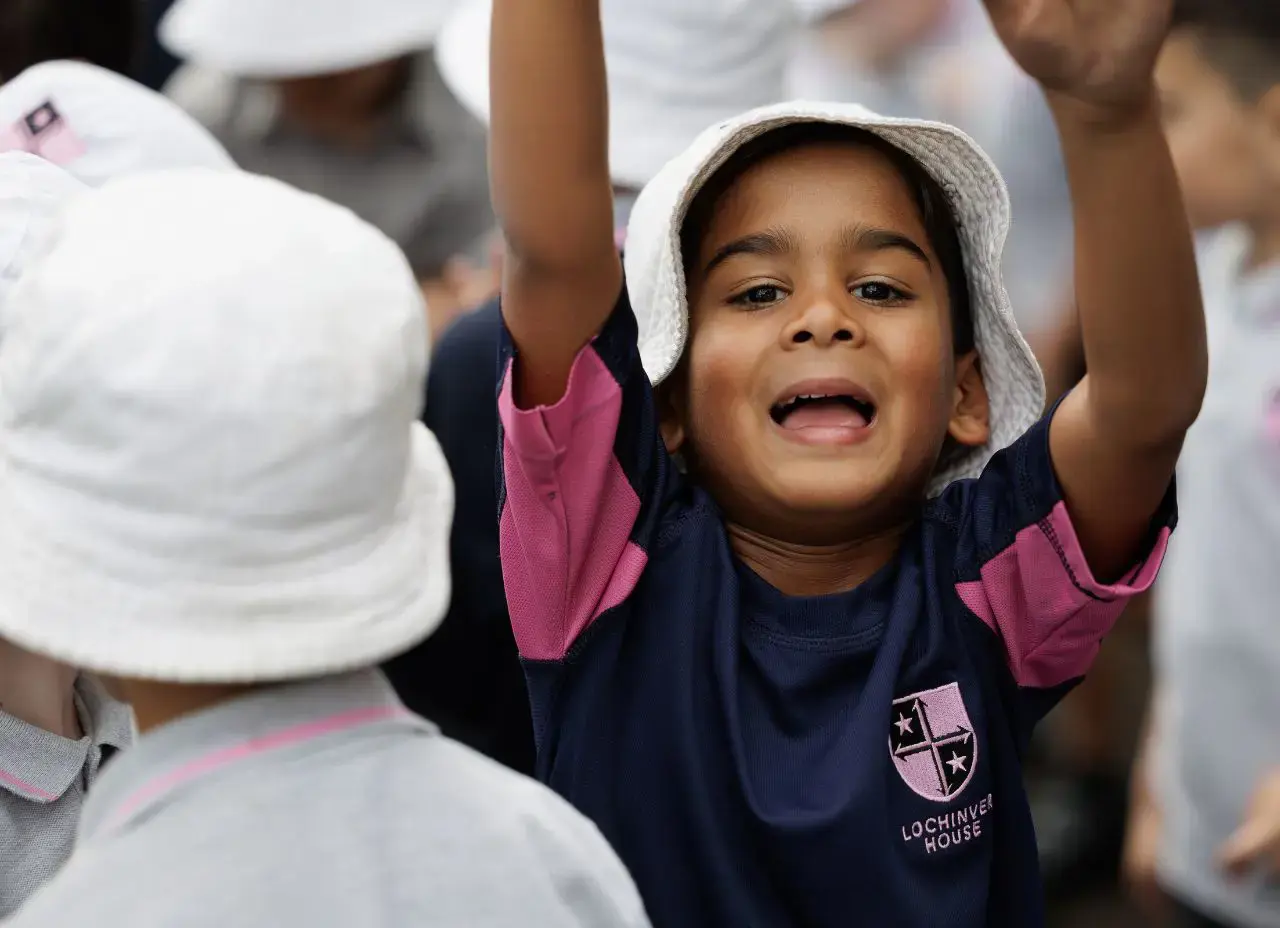 Fees page boy with hands in the airContent Image