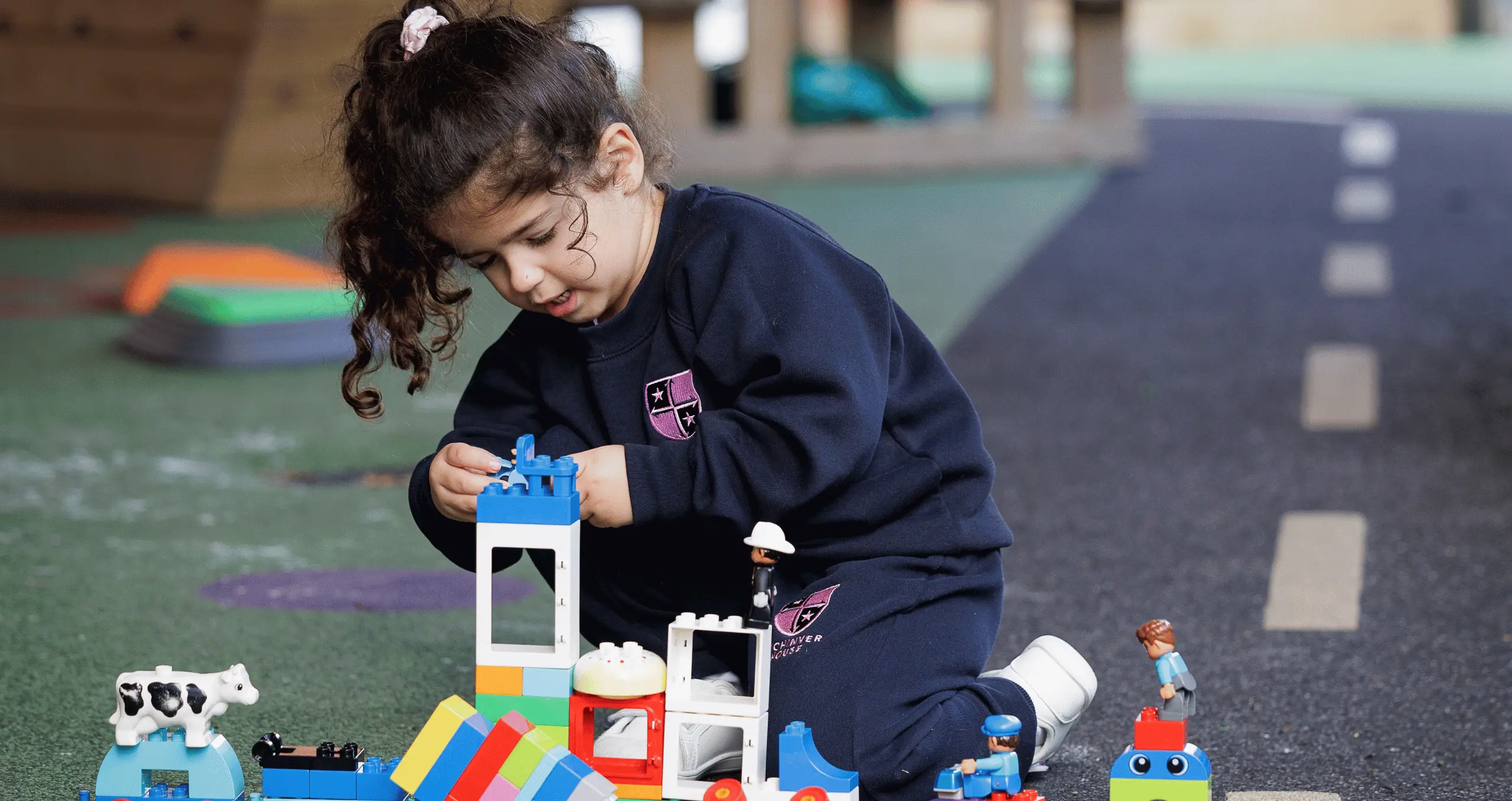 girl building Duplo in an afterschool activity