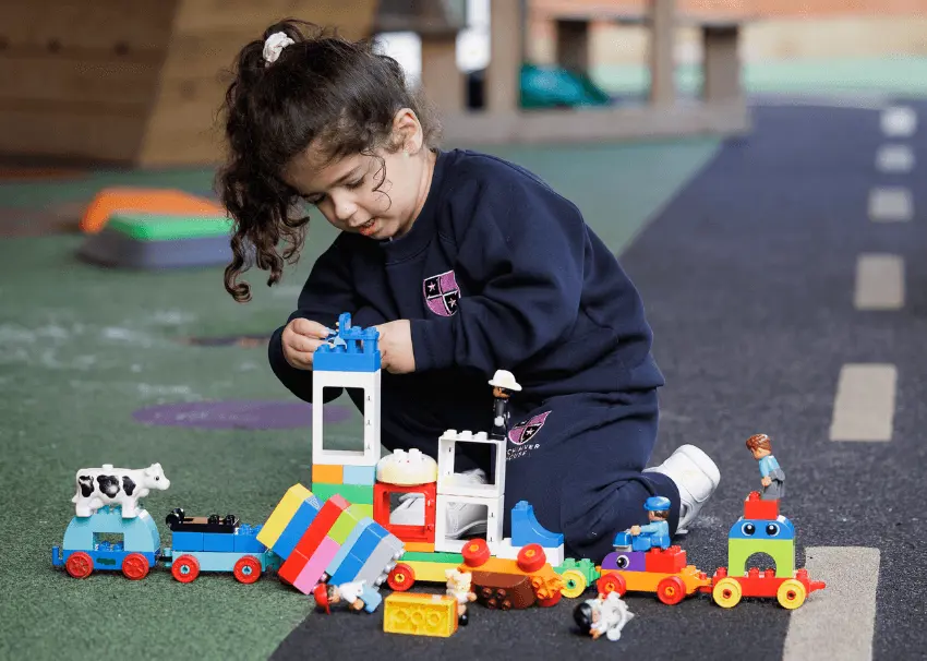 girl playing in pre prep outdoor area