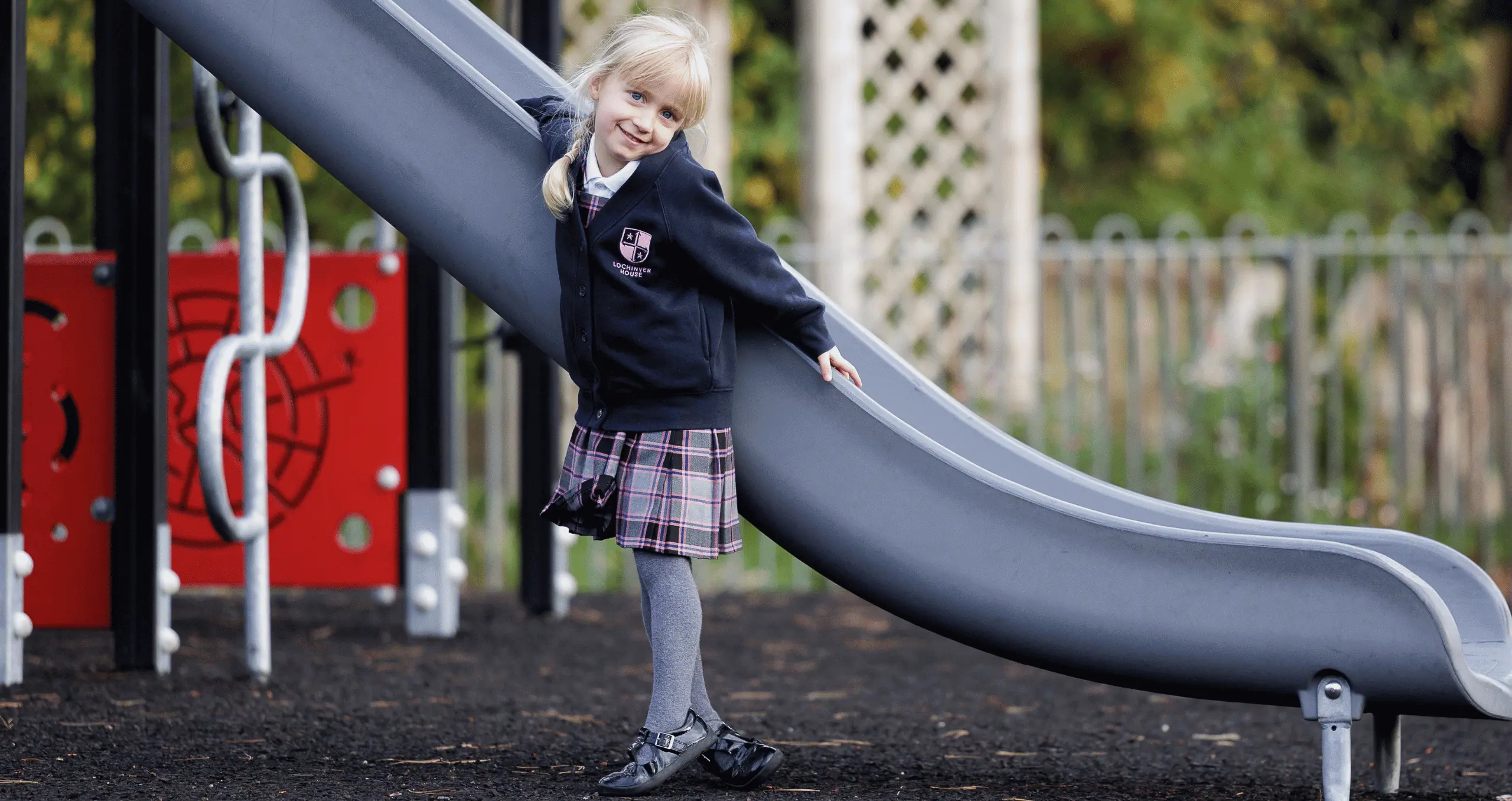 girl playing on slide at school