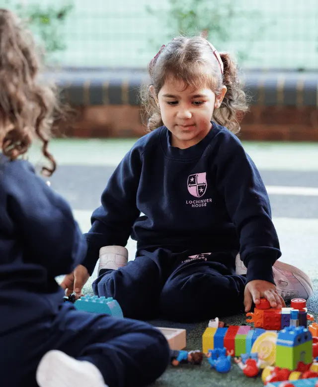 Girl playing with Duplo assessment