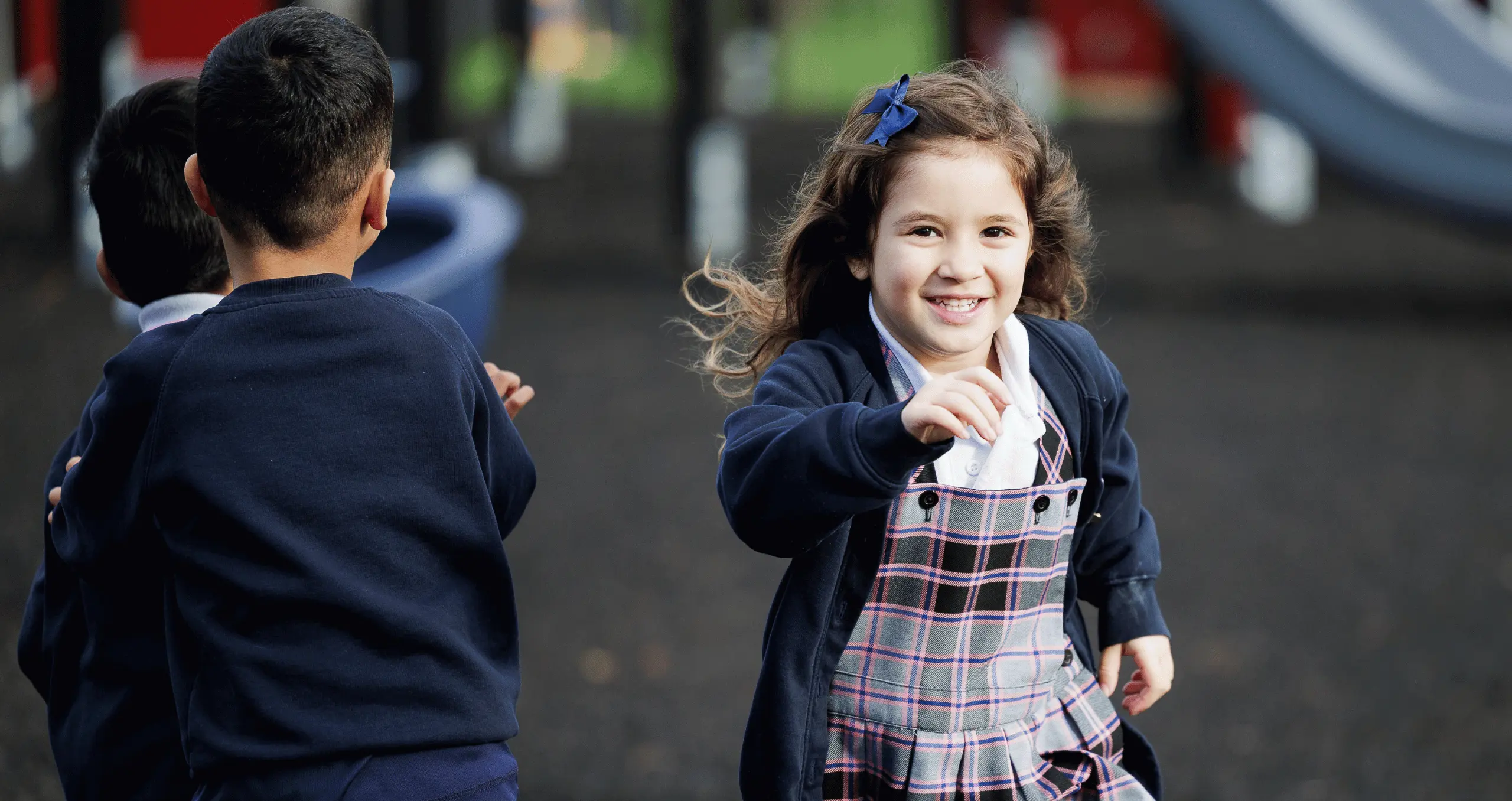 girl running past some boys at school