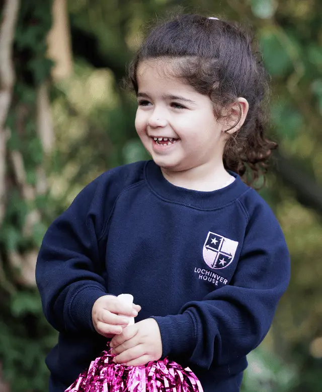 girl smiling with pom pom