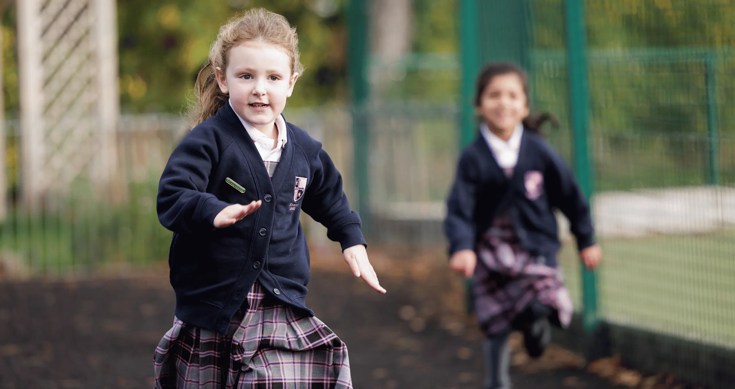 Girls running and playing in extended care provision