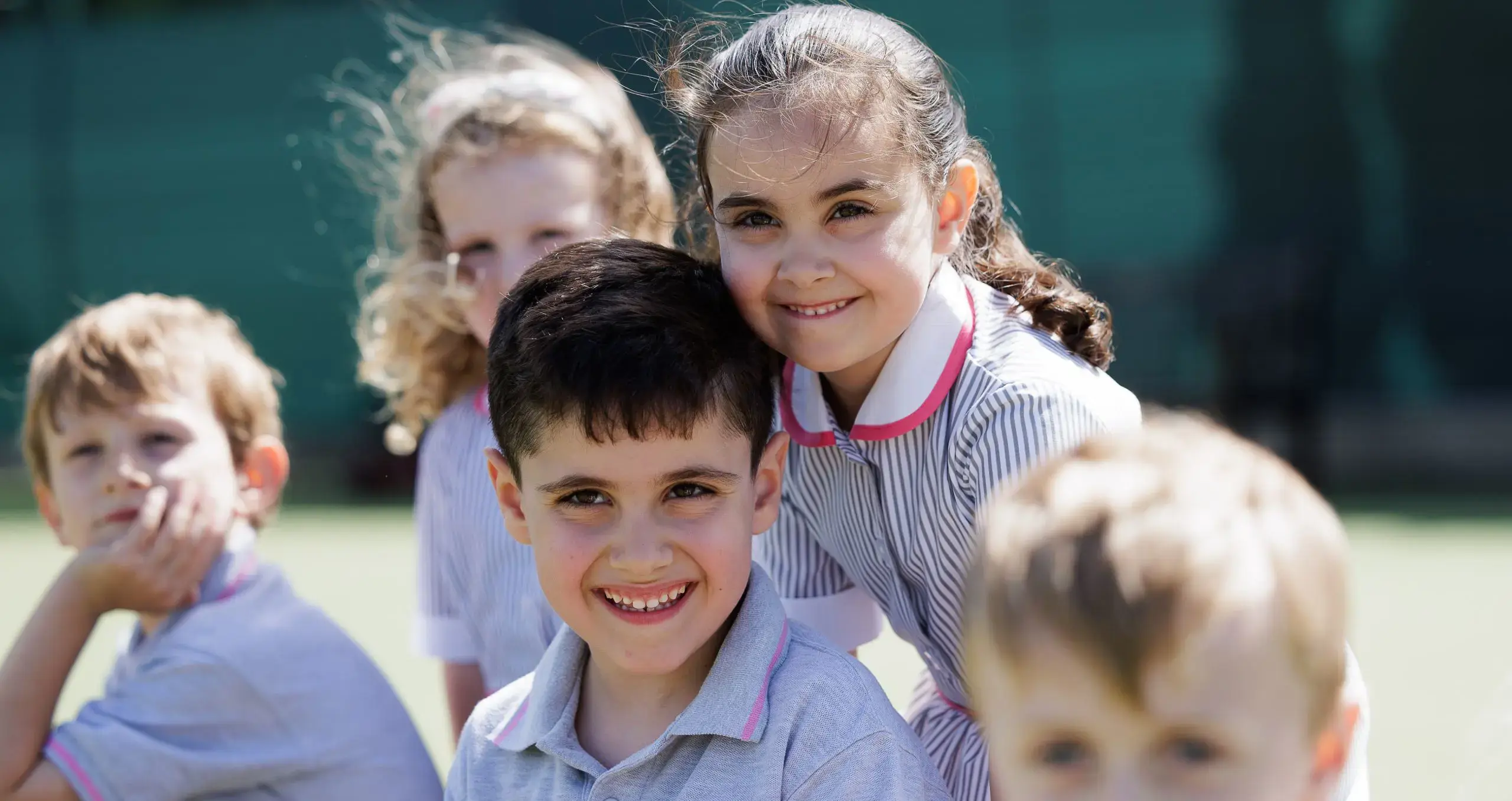 Young boys and girls playing together at school