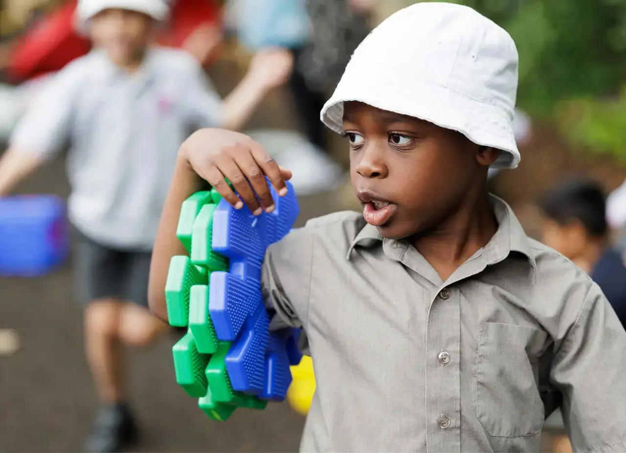 our history - boy carrying building blocksContent Image