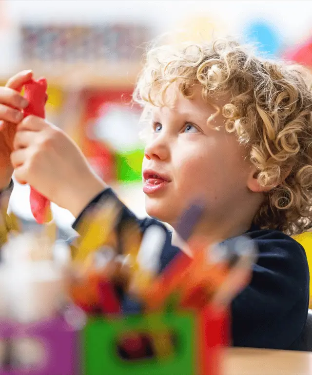 child playing with arts and crafts at stay and play session